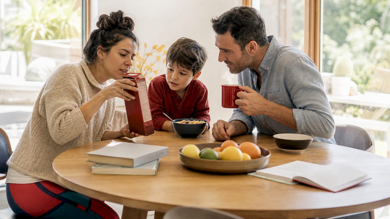 Family reading prebiotic ingredient label at kitchen table